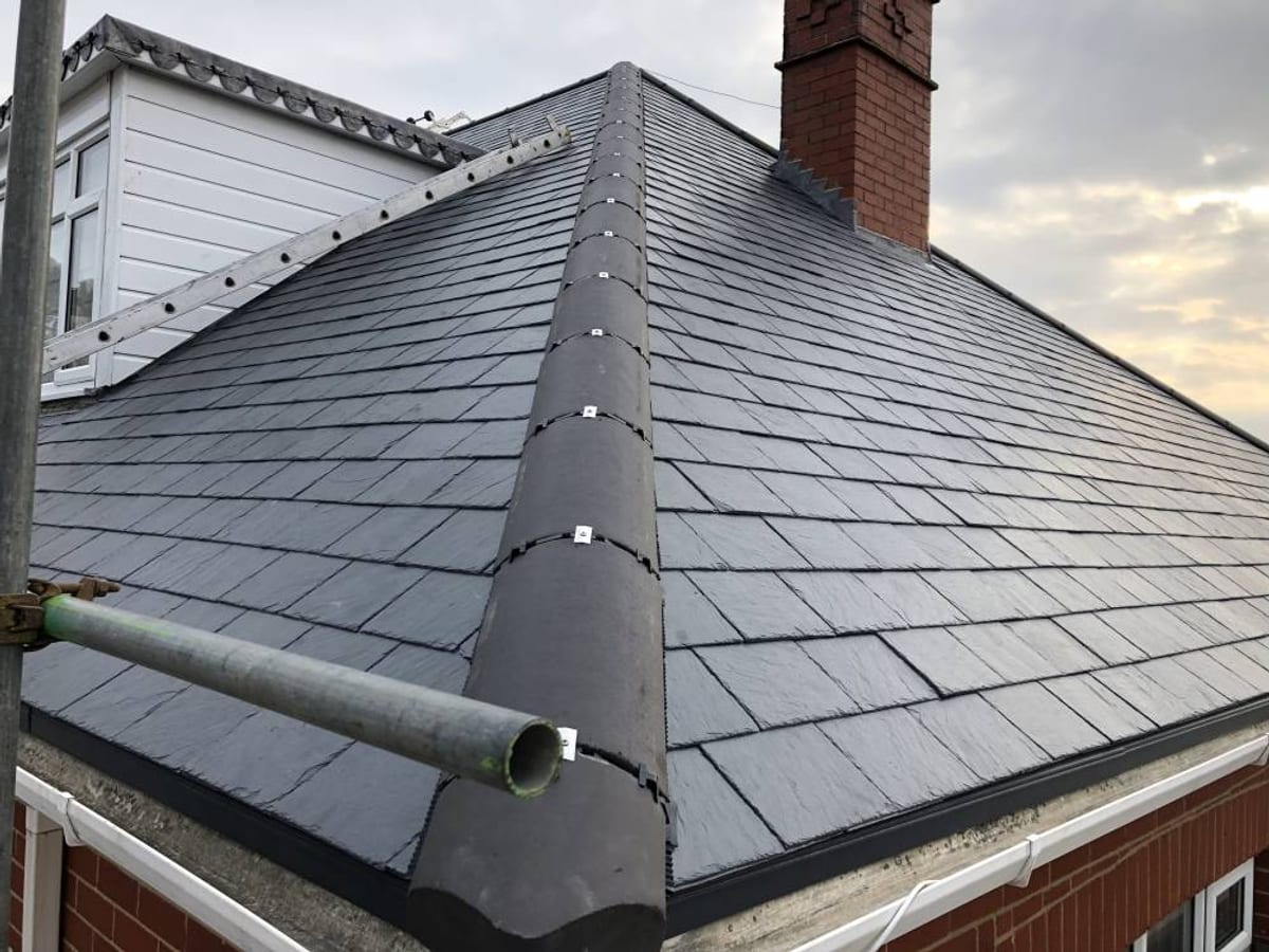 Slate hipped roof with a rebuilt chimney stack