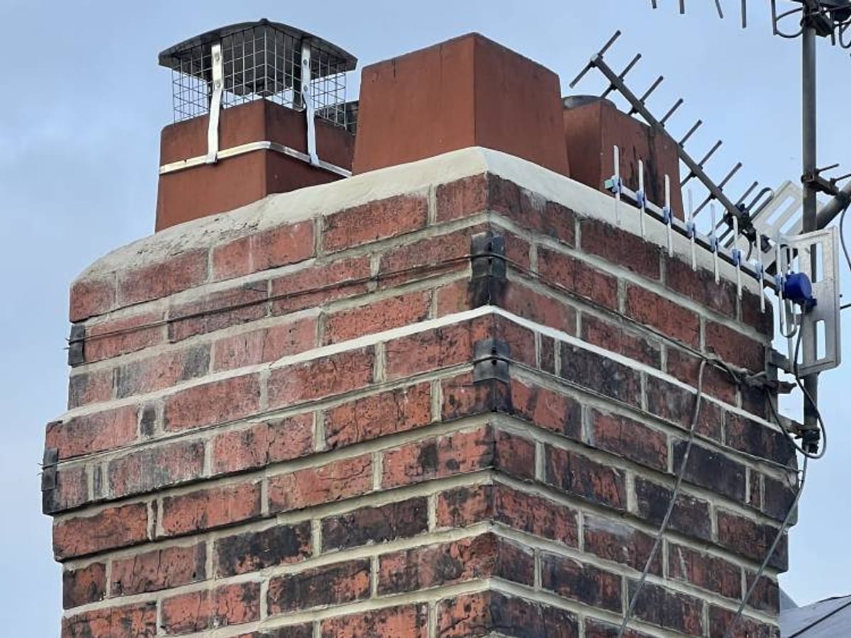 Rebuilt brick chimney stack with new lead flashing