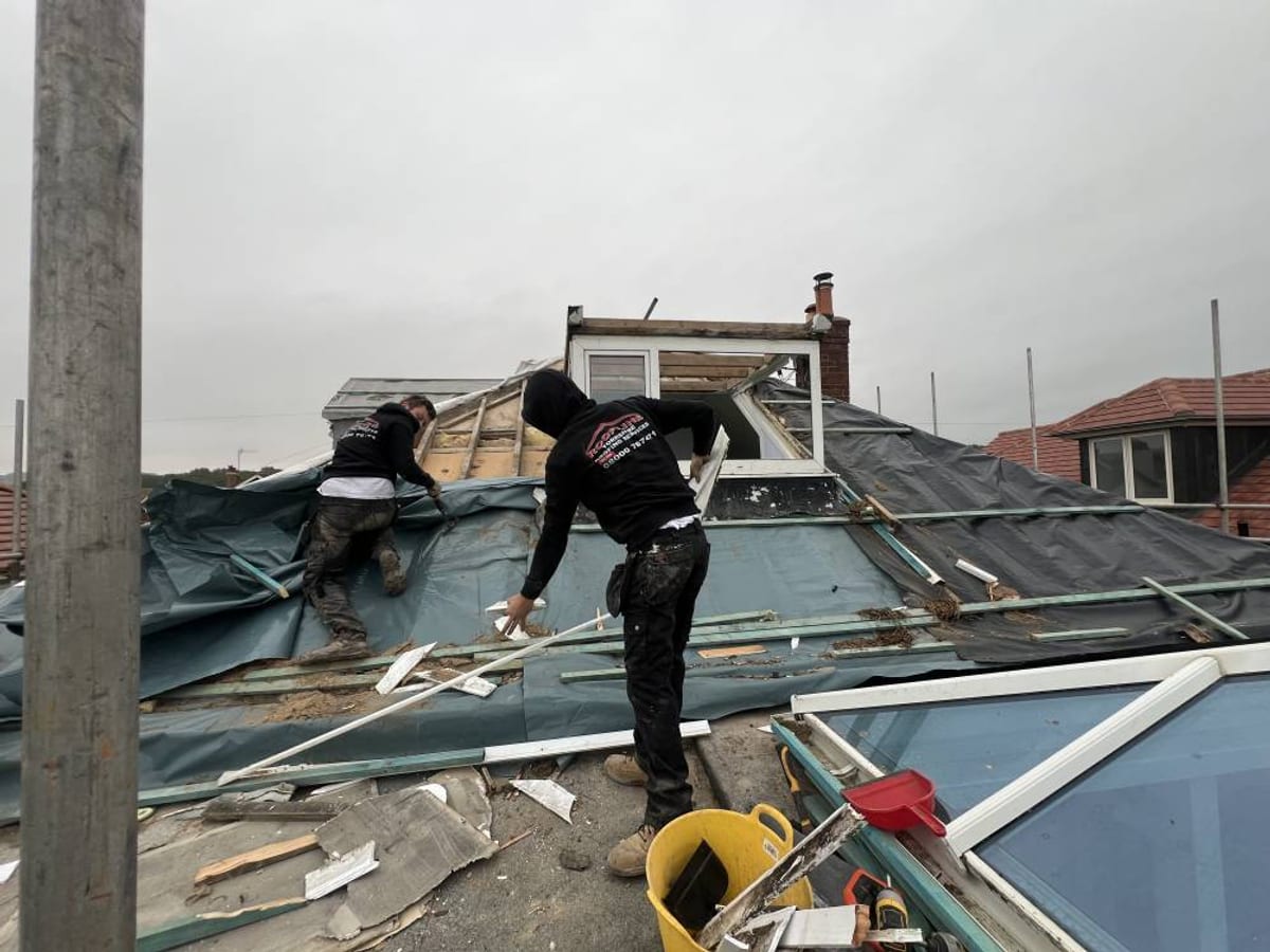 Roofer stripping a roof during a re-roof